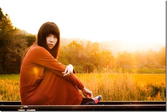 portrait-photography-woman-sitting-on-train-tracks